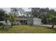 Front exterior view of a single-story home with an attached garage and simple landscaping at 5998 8Th S St, St Petersburg, FL 33705