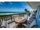Relax on the spacious balcony with comfortable seating and panoramic views of the beach at 614 Gulf Blvd # 4, Indian Rocks Beach, FL 33785