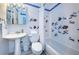 Bright bathroom with white tiles, colorful fish decorations, and well-maintained fixtures at 614 Gulf Blvd # 4, Indian Rocks Beach, FL 33785