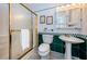 Classic bathroom with a shower, pedestal sink, and green and white tiled accents at 614 Gulf Blvd # 4, Indian Rocks Beach, FL 33785