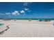 Scenic beach view, featuring pristine white sand, beach umbrellas, and clear blue waters under a sunny sky at 614 Gulf Blvd # 4, Indian Rocks Beach, FL 33785