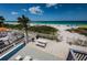 Stunning beach view from a tiled patio with white fencing, seating, picnic table, and barbeque grill at 614 Gulf Blvd # 4, Indian Rocks Beach, FL 33785