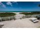 Relaxing view of the beach from the patio with a picnic table and a barbeque grill at 614 Gulf Blvd # 4, Indian Rocks Beach, FL 33785