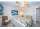 Serene bedroom with palm tree artwork, ceiling fan, and a comfortable bed at 614 Gulf Blvd # 4, Indian Rocks Beach, FL 33785