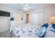 Comfortable bedroom featuring beach-themed bedding, a white dresser, and a ceiling fan at 614 Gulf Blvd # 4, Indian Rocks Beach, FL 33785