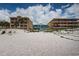 Exterior shows the property near the beach, framed by neighboring buildings at 614 Gulf Blvd # 4, Indian Rocks Beach, FL 33785