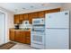 Well-equipped kitchen with white appliances, ample counter space, and wood cabinetry at 614 Gulf Blvd # 4, Indian Rocks Beach, FL 33785
