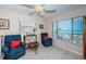 Cozy living room featuring comfortable seating, beach decor, and scenic ocean views through large windows at 614 Gulf Blvd # 4, Indian Rocks Beach, FL 33785