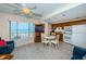Spacious living room with ocean views, a ceiling fan, TV, and an eat-in kitchen at 614 Gulf Blvd # 4, Indian Rocks Beach, FL 33785