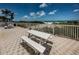 Picnic table on a brick patio looks out to lush dunes and a white sandy beach at 614 Gulf Blvd # 4, Indian Rocks Beach, FL 33785