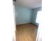 Vacant bedroom featuring wood floors, window, and light-blue walls at 6601 Ranger Dr, Tampa, FL 33615