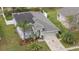 Home with neat landscaping, driveway leading to the garage, solar panels on the roof, and a well-maintained lawn at 7531 Jeno St, Zephyrhills, FL 33540