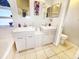 Bathroom featuring a double vanity, tile floors, and a separate tub and shower at 7534 Beacon Woods Dr, Hudson, FL 34667