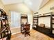 Bright home office features natural light from large windows and wood flooring at 7534 Beacon Woods Dr, Hudson, FL 34667