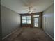 Bedroom with a window, a door to the outside and ceiling fan at 8530 Alexandra Arbor Ln, Temple Terrace, FL 33637