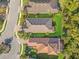 This is an aerial view of a neighborhood with lush green lawns and beautiful tiled roofs at 9708 Highland Park Pl, Palmetto, FL 34221