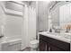 Well-lit bathroom featuring a shower-tub combination, modern fixtures, and sleek vanity at 9708 Highland Park Pl, Palmetto, FL 34221