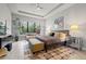 Bright bedroom with large window, tray ceiling, and contemporary decor at 9708 Highland Park Pl, Palmetto, FL 34221