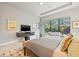 Bedroom features a large window with a view of lush greenery and natural light at 9708 Highland Park Pl, Palmetto, FL 34221