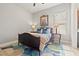 Cozy bedroom featuring a woven bed frame, colorful rug, and natural light from the window at 9708 Highland Park Pl, Palmetto, FL 34221