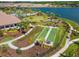 An aerial view of community amenities including a bocce ball court, pool and lounge area at 9708 Highland Park Pl, Palmetto, FL 34221