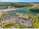 Aerial view of community amenities including tennis courts, pool, clubhouse, and parking at 9708 Highland Park Pl, Palmetto, FL 34221
