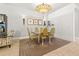 Elegant dining room area with seating for six and an ornate chandelier at 9708 Highland Park Pl, Palmetto, FL 34221