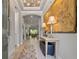 Elegant foyer features a decorative ceiling, chandelier, and large artwork for a grand entrance at 9708 Highland Park Pl, Palmetto, FL 34221