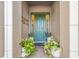 Inviting entryway with a decorative front door, potted plants, and stylish accents at 9708 Highland Park Pl, Palmetto, FL 34221