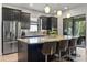 Contemporary kitchen featuring a large island, stainless steel appliances, and sleek dark cabinetry at 9708 Highland Park Pl, Palmetto, FL 34221