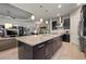 Spacious kitchen with a large center island, granite countertops, dark wood cabinets, and stainless steel appliances at 9708 Highland Park Pl, Palmetto, FL 34221