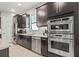 Modern kitchen features stainless steel appliances, granite countertops, and dark wood cabinetry at 9708 Highland Park Pl, Palmetto, FL 34221