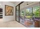 Screened lanai featuring outdoor seating and views of the lush backyard at 9708 Highland Park Pl, Palmetto, FL 34221