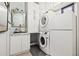 Clean laundry area equipped with a washer, dryer, and storage at 9708 Highland Park Pl, Palmetto, FL 34221
