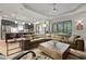 Open-concept living room featuring a sectional sofa and view of the modern kitchen at 9708 Highland Park Pl, Palmetto, FL 34221