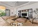 Comfortable living room with a large sectional sofa, stylish chair, and modern entertainment center at 9708 Highland Park Pl, Palmetto, FL 34221