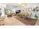 Open-concept living space with a dining area, a cozy sectional, and seamless indoor-outdoor transition at 9708 Highland Park Pl, Palmetto, FL 34221