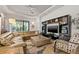 Spacious living room boasts comfortable seating, a modern ceiling fan, and natural light at 9708 Highland Park Pl, Palmetto, FL 34221