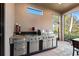 Outdoor kitchen with stainless steel grill, sink, and granite countertops, perfect for al fresco dining and entertaining at 9708 Highland Park Pl, Palmetto, FL 34221