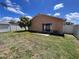 View of the backyard featuring a patio, fence, and sliding glass door into the house at 10102 Cedar Dune Dr, Tampa, FL 33624