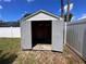 Backyard shed with open doors showing ample storage and side yard views at 10102 Cedar Dune Dr, Tampa, FL 33624