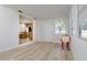 Open-concept living room with light walls and flooring, opening into the kitchen at 10535 109Th St, Largo, FL 33778