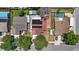 Aerial view of a house with solar panels, a red roof, and a nearby pool at 1081 N Euclid Ave, Sarasota, FL 34237