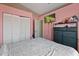 This is a pink bedroom with a television, a dresser, and a view of the closet and doorway at 1081 N Euclid Ave, Sarasota, FL 34237