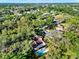 A picturesque aerial view of the property showcasing its pool and neighborhood setting among lush trees at 11712 Palmer Dr, Tampa, FL 33624