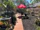 Cozy backyard with plants, mulch ground cover, and a seating area with umbrella at 11712 Palmer Dr, Tampa, FL 33624