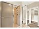 Bathroom featuring a glass-enclosed shower and a mirrored door to the walk-in closet and water closet at 11712 Palmer Dr, Tampa, FL 33624