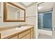 Bathroom features single sink vanity, mirror, and bathtub shower combo at 11712 Palmer Dr, Tampa, FL 33624