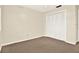 Neutral bedroom featuring a closet with bi-fold doors and neutral walls and carpet at 11712 Palmer Dr, Tampa, FL 33624