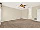 Comfortable bedroom featuring neutral color palette, ceiling fan, and plush carpet flooring at 11712 Palmer Dr, Tampa, FL 33624